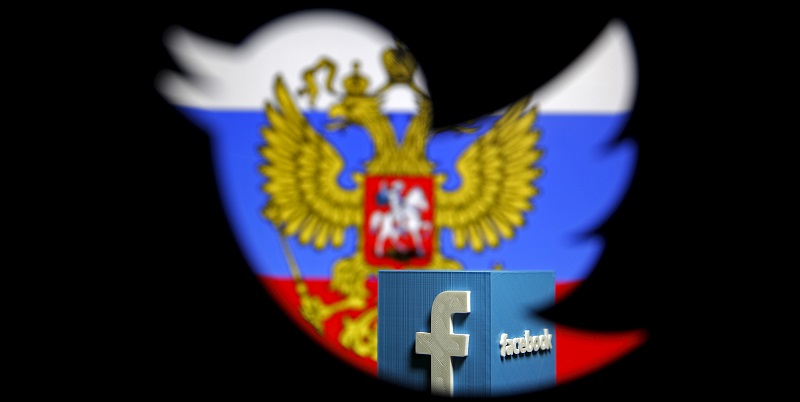 A Russian flag and a 3D model of the Facebook logo is seen through a cutout of the Twitter logo in this photo illustration taken in Zenica, Bosnia and Herzegovina, May 22, 2015. Russia's media watchdog has written to Google, Twitter and Facebook warning them against violating Russian Internet laws and a spokesman said on Thursday they risk being blocked if they do not comply with the rules. Roskomnadzor said it had sent letters this week to the three U.S.-based Internet firms asking them to comply with Internet laws which critics of President Vladimir Putin have decried as censorship. REUTERS/Dado Ruvic TPX IMAGES OF THE DAY - GF10000104110