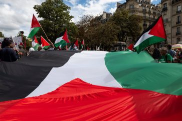 Des manifestants brandissent un grand drapeau palestinien (Illustration)